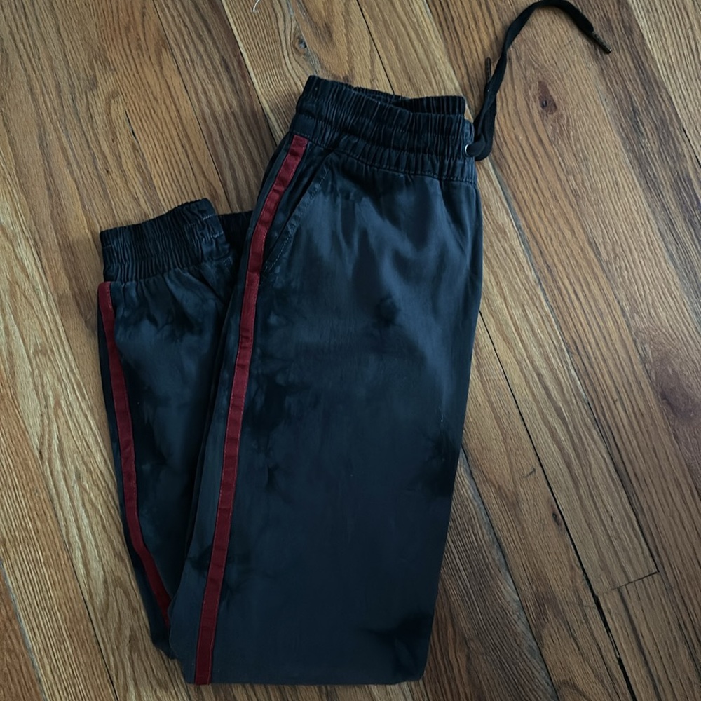 Aqua jogger black tie dye with deep red ribbon tacing stripe on sides.